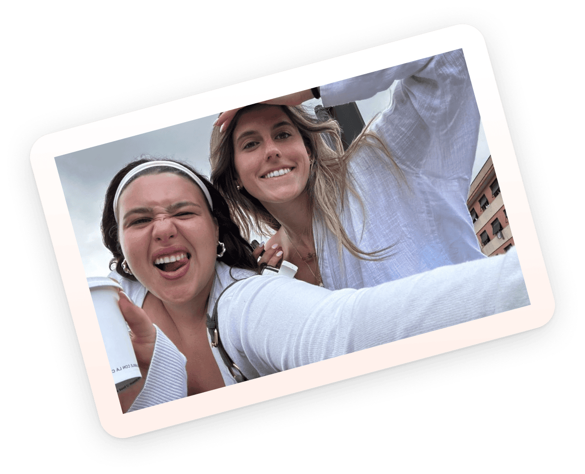 Two friends taking a playful selfie outdoors, laughing and enjoying their time together, showing how easy it is to stay connected.